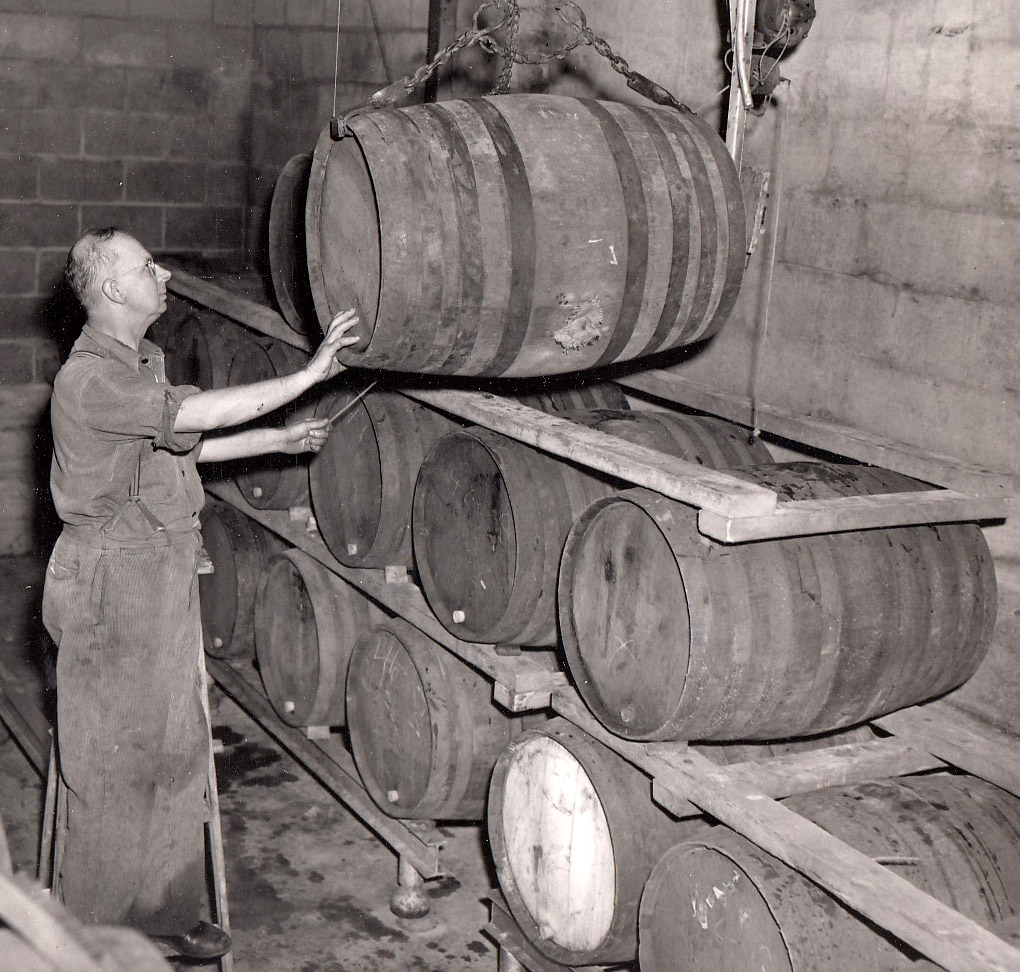 Albert Klingshirn hoisting barrels with a chain lift