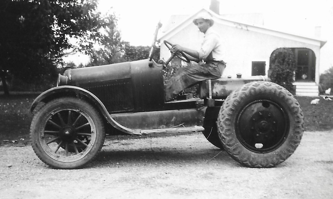 Old photo of Roman Klingshirn on what looks like a car with rear tractor tires.