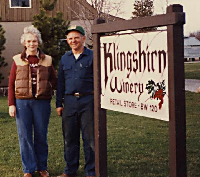 Photo of Allan and Barbara Klingshirn next to the winery sign