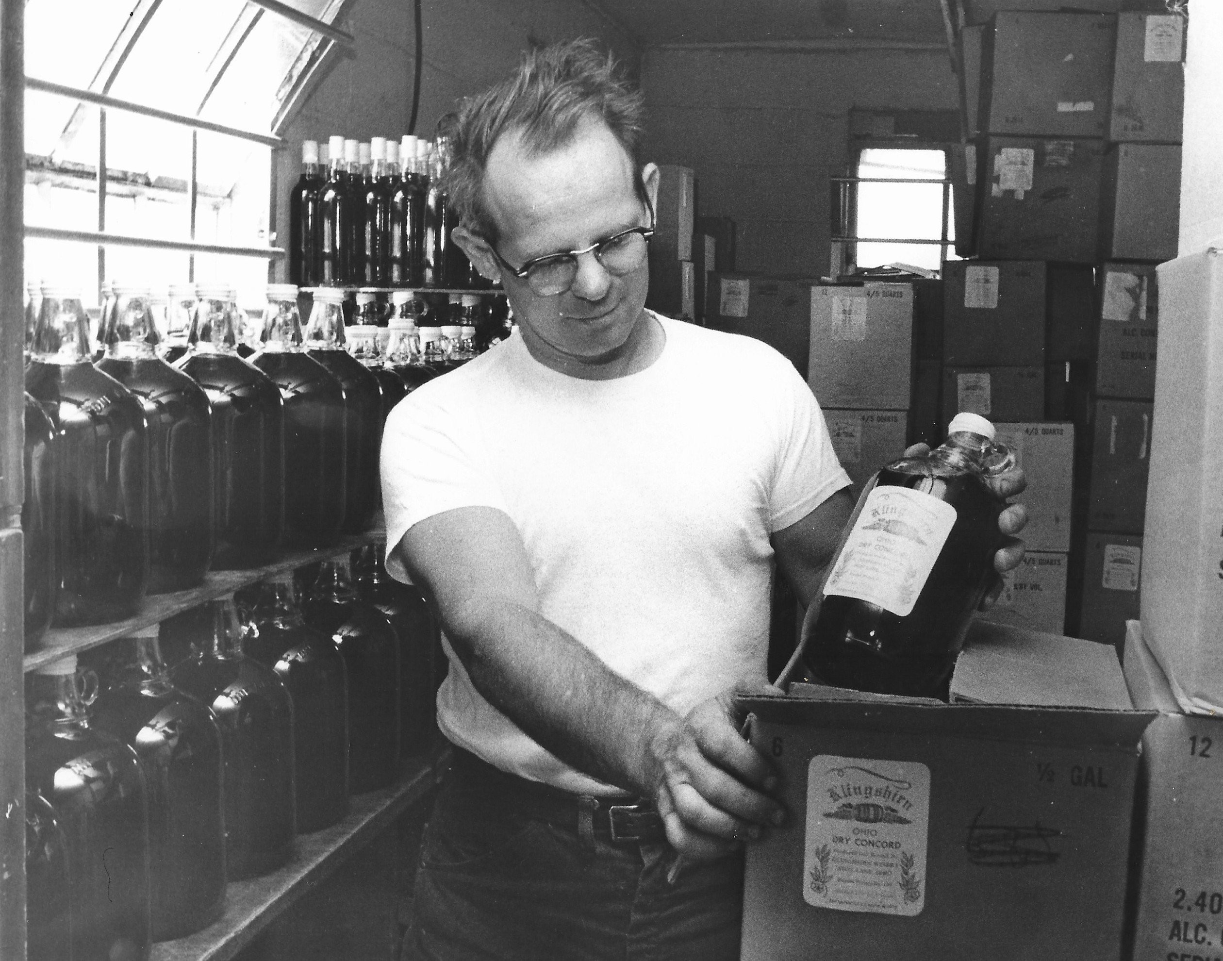 Allan Klingshirn putting a wine bottle in a case